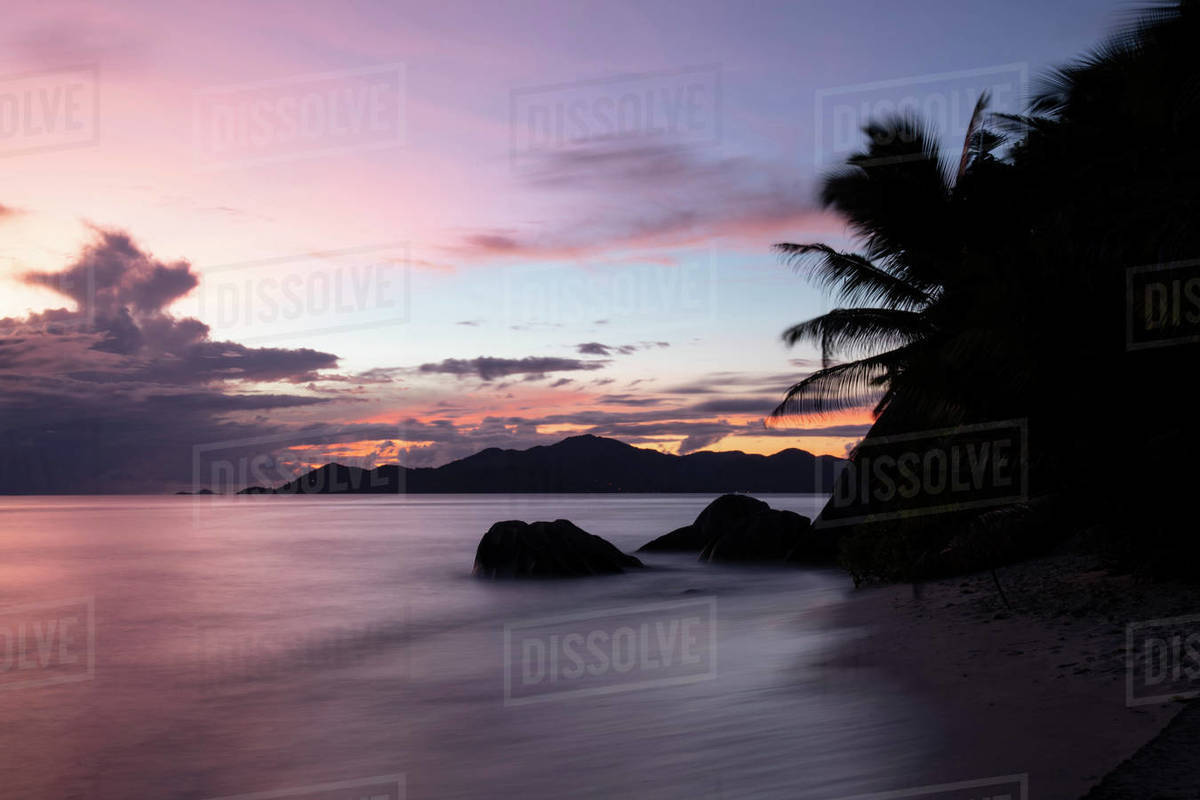 Sunset at Anse Source d'Argent looking toward Praslin, Union Estate Park, La Digue, Seychelles, Indian Ocean, Africa Royalty-free stock photo