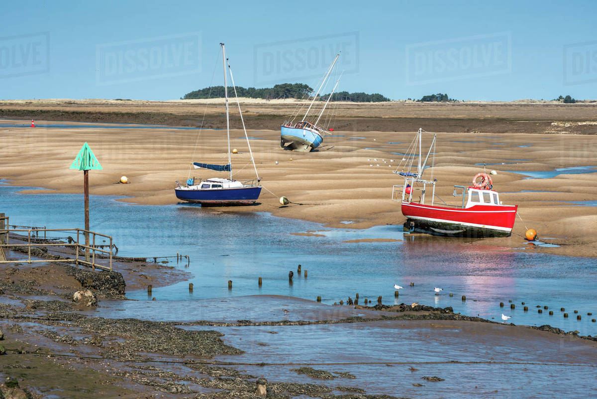 Colourful boats on sandbanks low tide, East Fleet river estuary, Wells next the sea, North Norfolk coast, Norfolk, East Anglia, England, United Kingdom, Europe Royalty-free stock photo