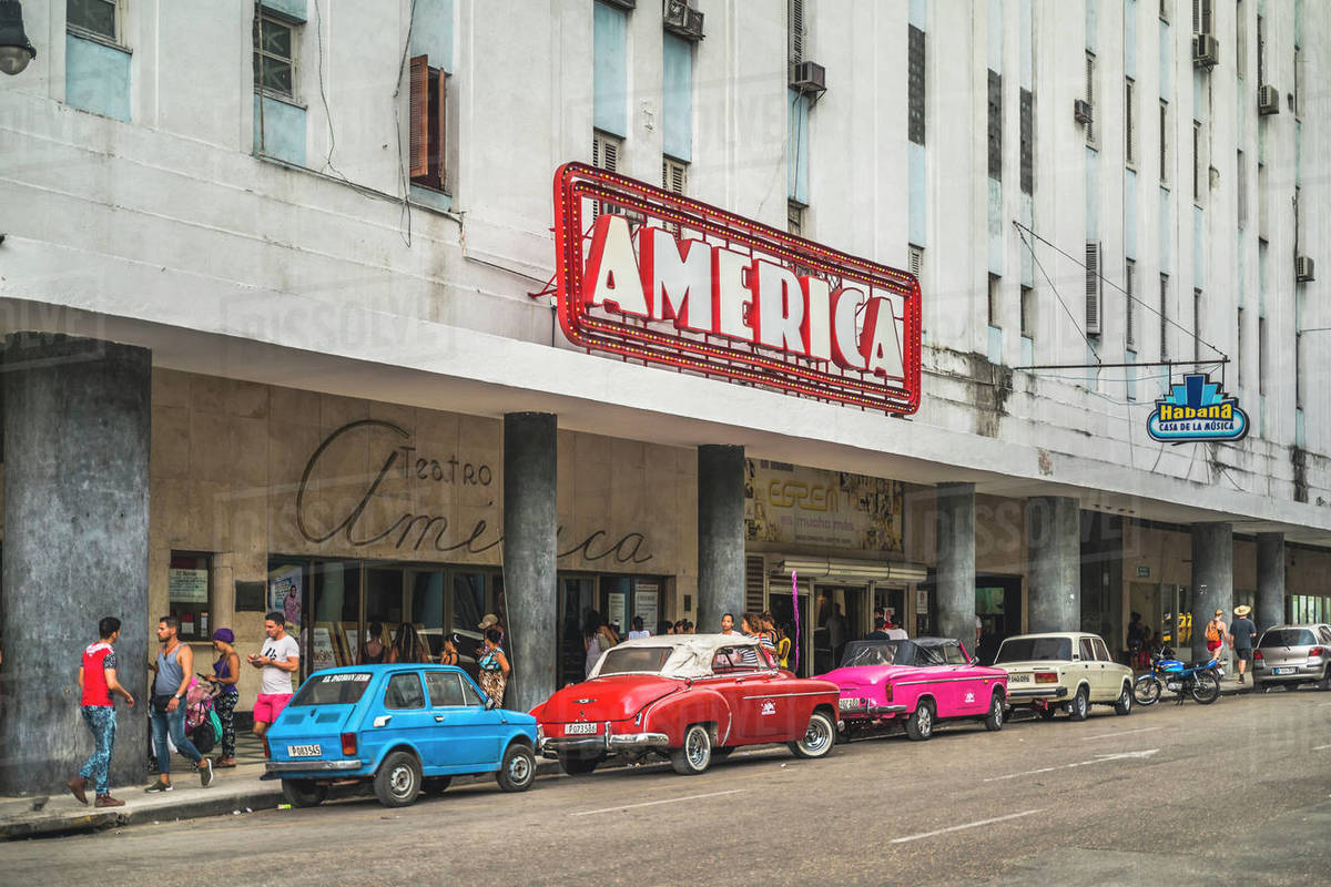 Old vintage cars parked outside Teatro America, La Habana (Havana), Cuba, West Indies, Caribbean, Central America Royalty-free stock photo