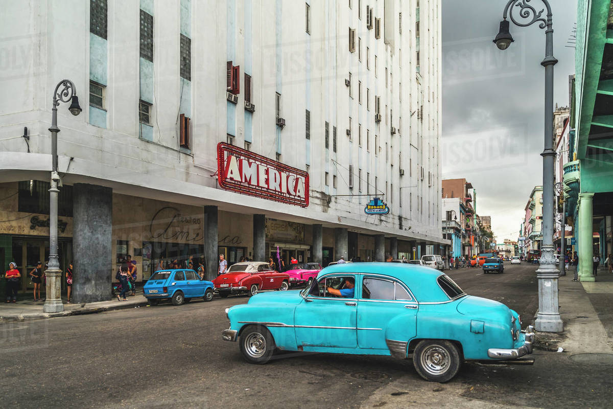 Old vintage cars parked outside Teatro America, La Habana (Havana), Cuba, West Indies, Caribbean, Central America Royalty-free stock photo