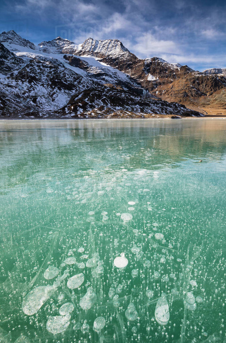 Ice Bubbles In The Turquoise Water Of The Frozen White Lake Lago 