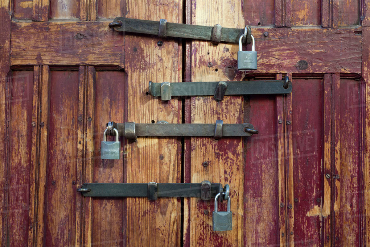 Mexico, San Miguel de Allende. Detail of wooden door with four locks ... Mexico, San Miguel de Allende. Detail of wooden door with four locks ...