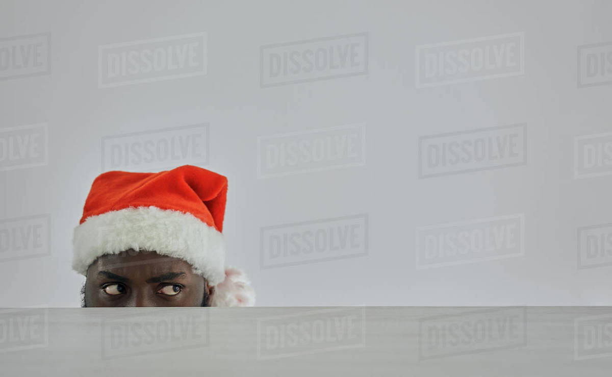 The african man in the red hat watching from the table Royalty-free stock photo