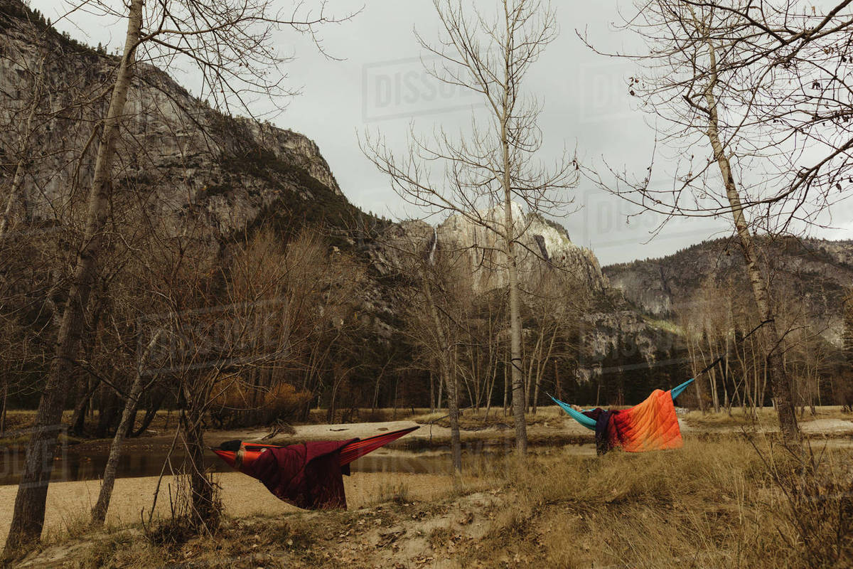 Two women reclining in hammocks at Yosemite National Park, California