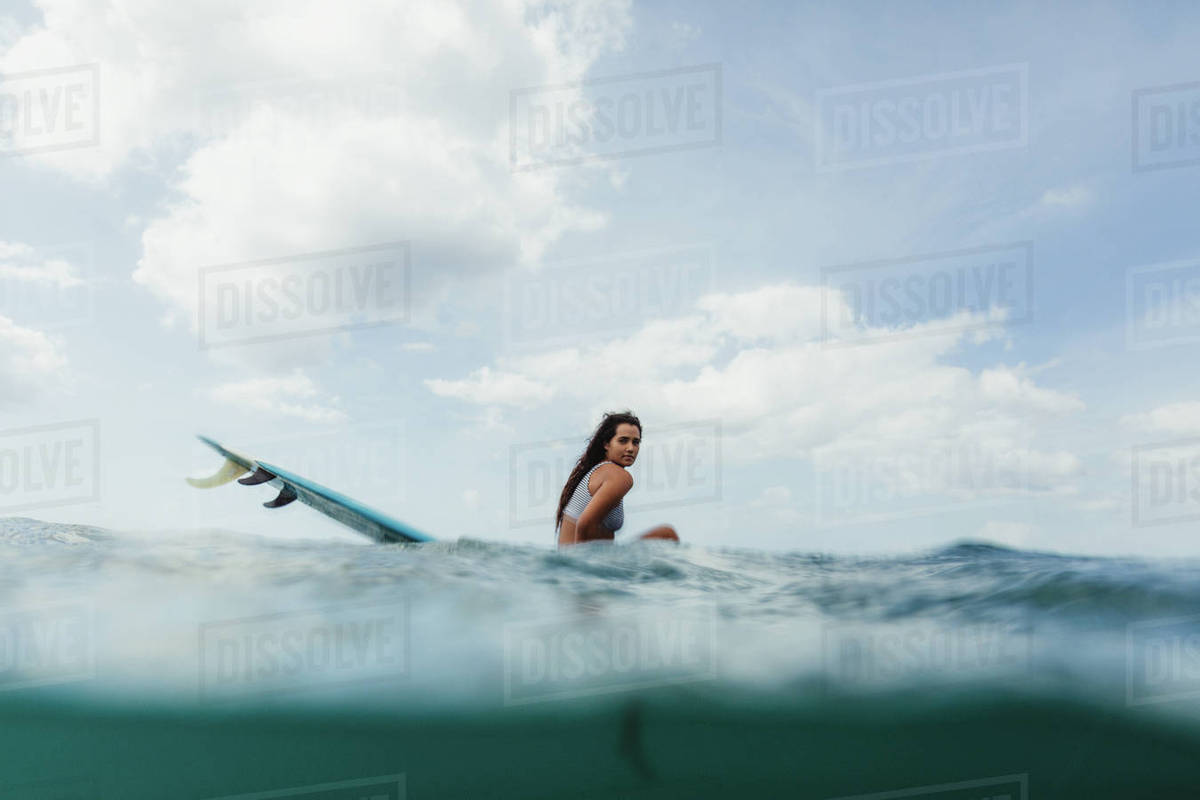 Surface level view of woman on surfboard looking at camera, Oahu, Hawaii, USA Royalty-free stock photo