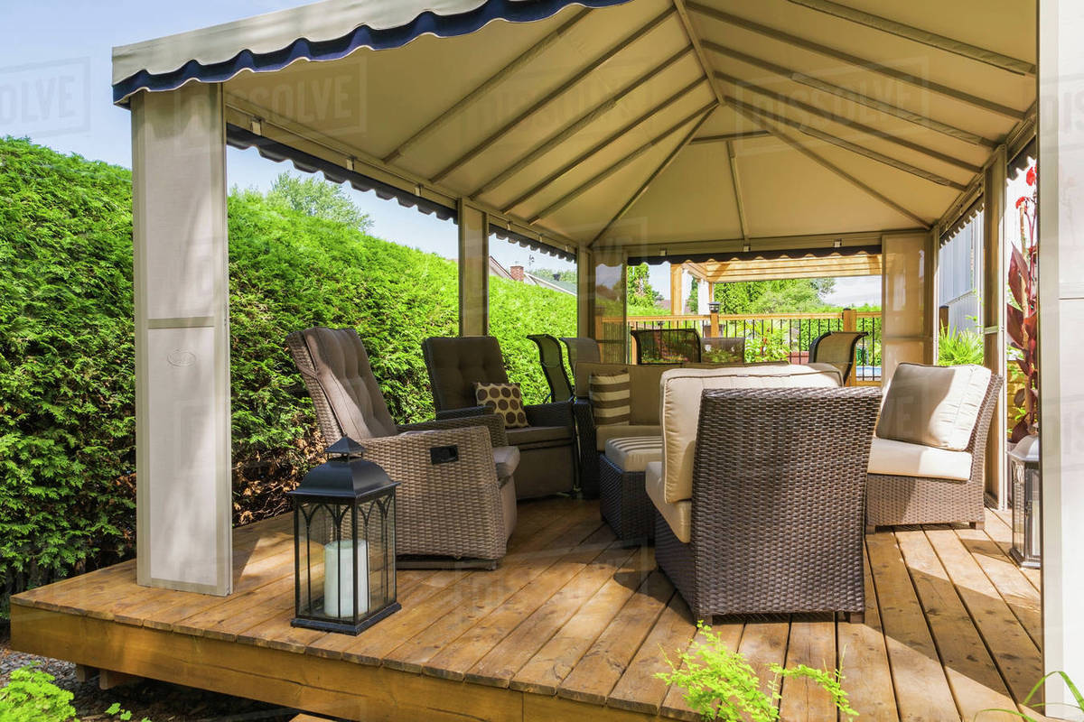 Gazebo On Wooden Deck Furnished With Wicker Furniture Quebec Gazebo On Wooden Deck Furnished With