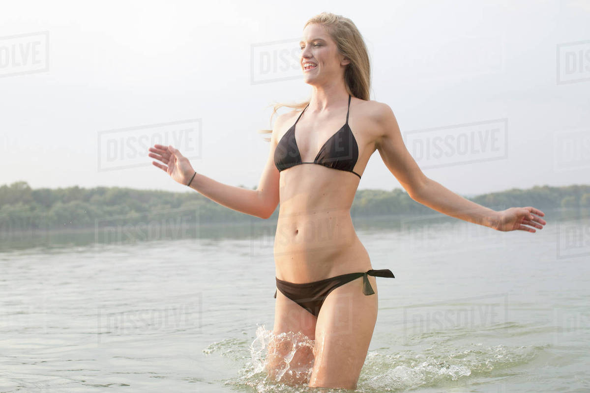 Woman in bikini splashing in river Royalty-free stock photo