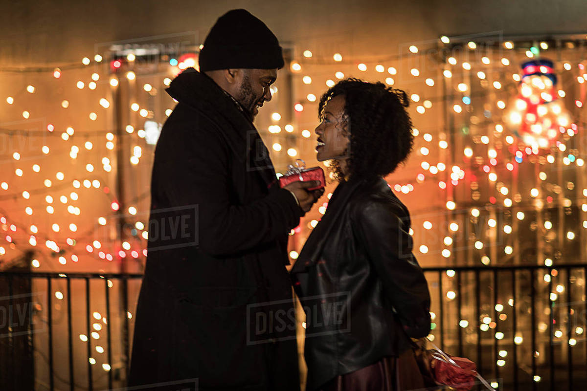 Romantic Couple Handing Christmas Gifts At Night New York Usa Romantic Couple Handing Christmas Gifts At Night New York Usa