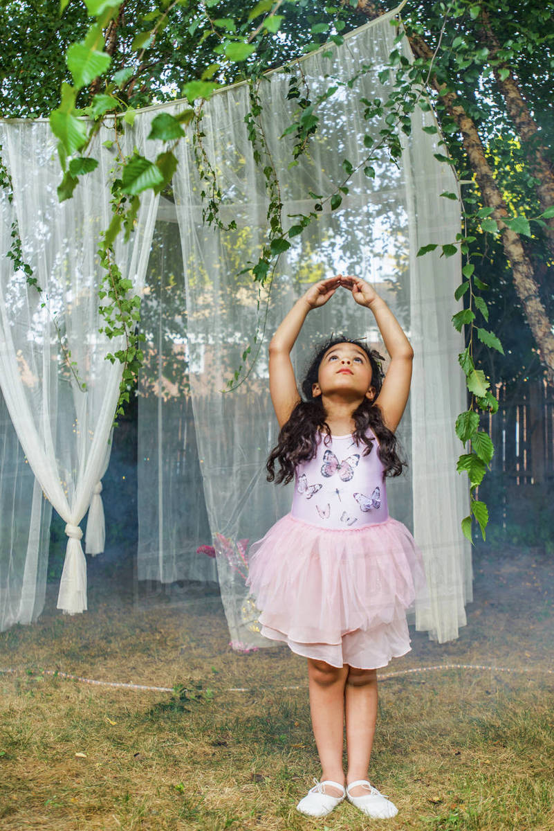 Portrait of young girl, dressed as fairy, dancing outdoors Royalty-free stock photo