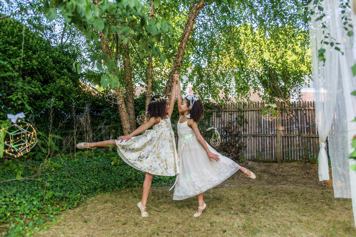 Two young girls, dressed as fairies, dancing outdoors Royalty-free stock photo