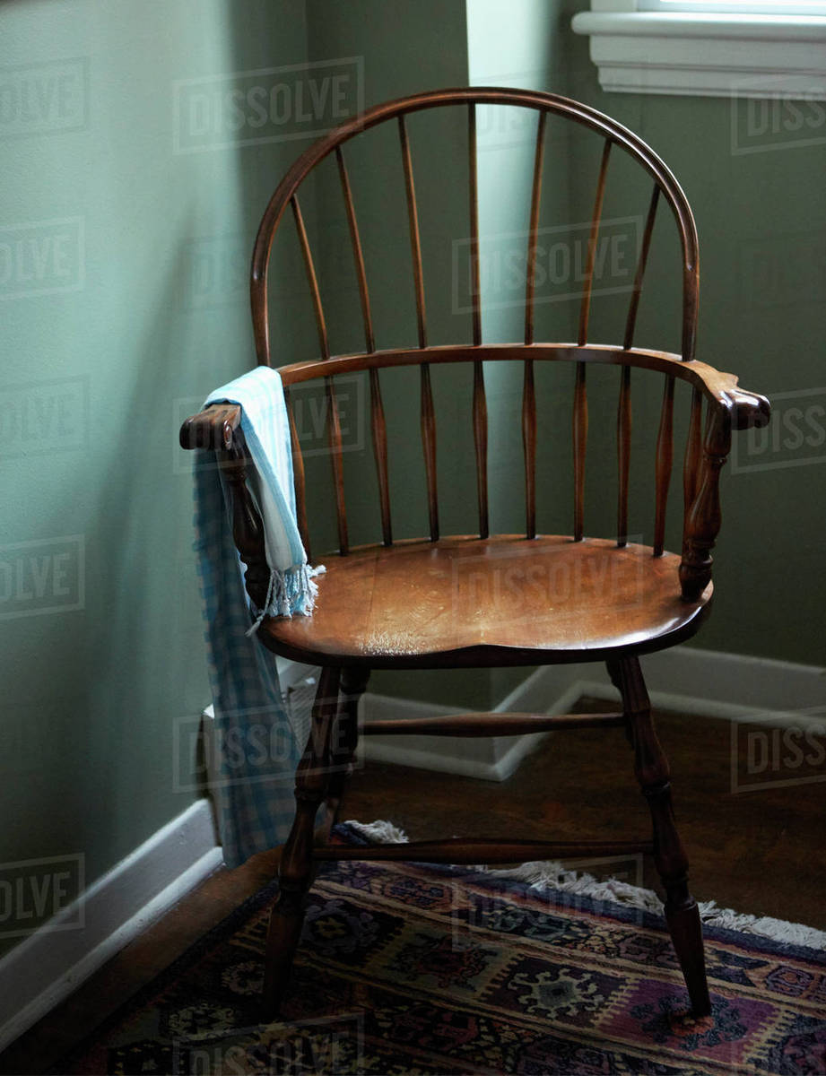 Empty chair in corner of room Stock Photo Dissolve