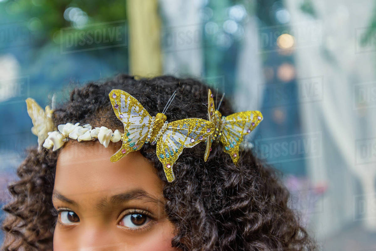 Portrait of young girl wearing butterflies in hair, close-up Royalty-free stock photo
