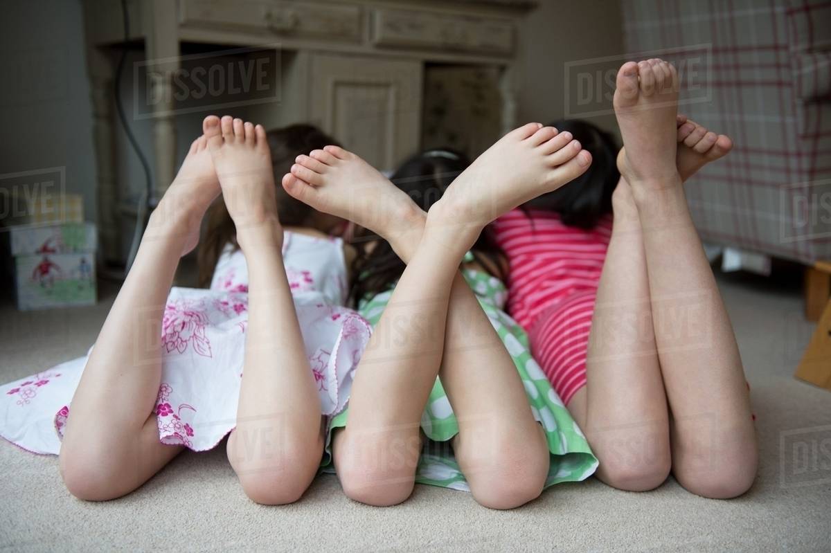 Girls Lying On Floor Together With Feet Up Girls Lying On Floor Together With Feet Up