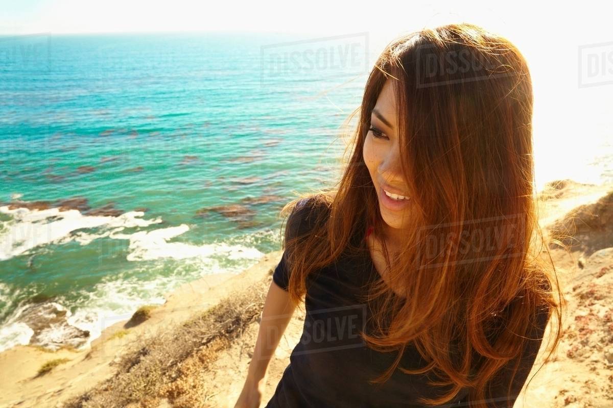 Young woman on cliff path, Palos Verdes, California, USA Stock Photo Dissolve