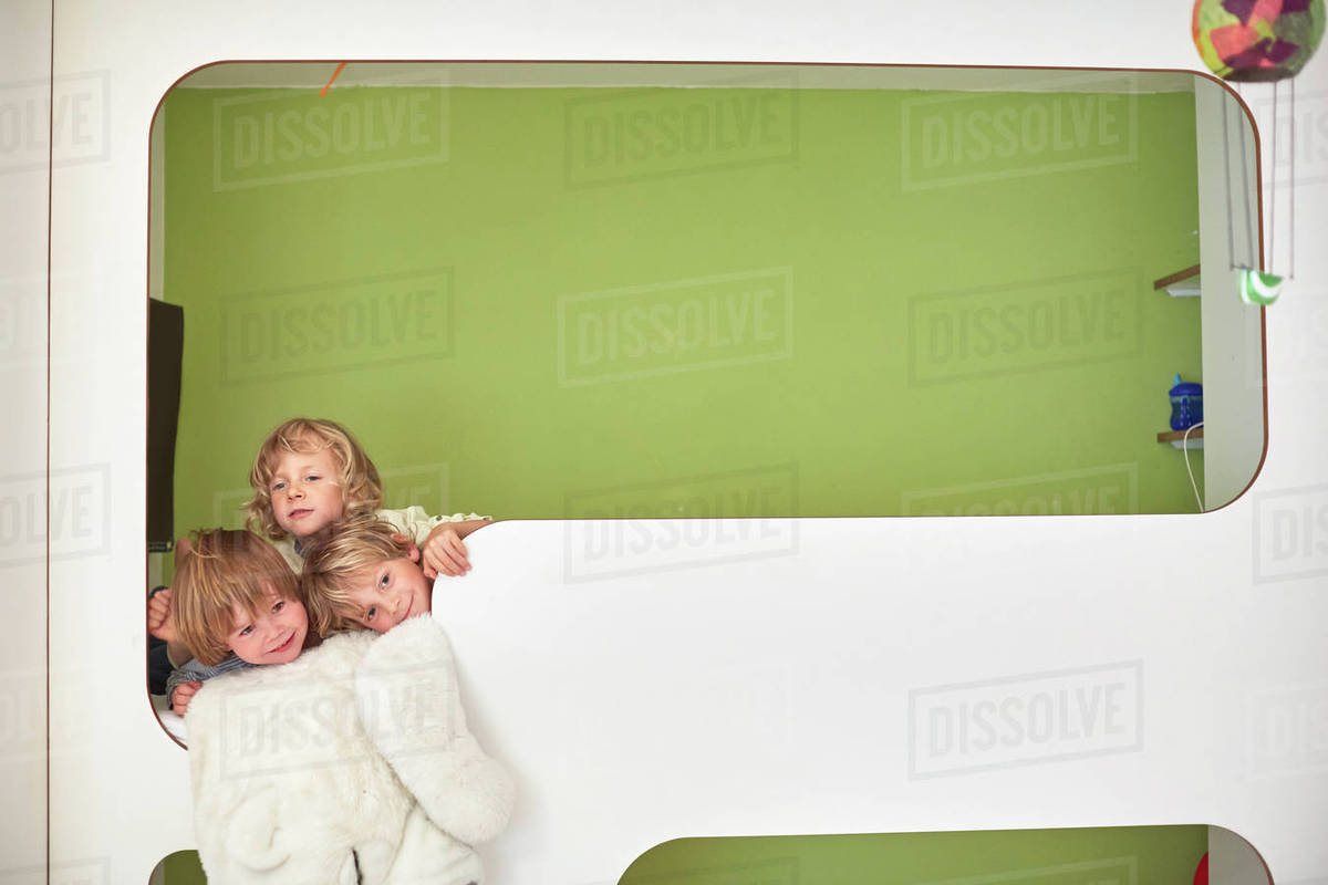 Three boys together on the top bunk of bunk beds, head and shoulders Stock Photo Dissolve