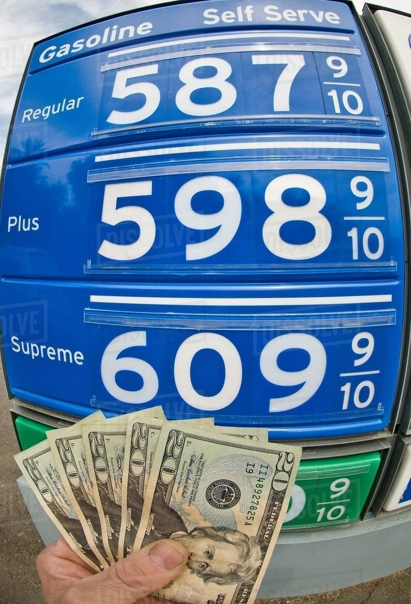 Hand holding dollar bills at gas station in Death Valley National Park