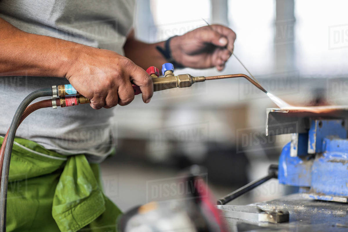 Cropped view of man welding in bodywork repair shop Stock Photo