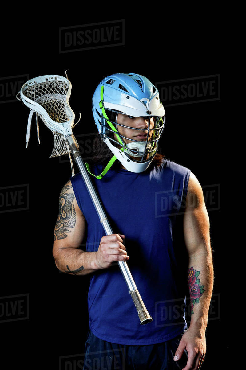 Portrait of lacrosse player, black background - Stock Photo - Dissolve