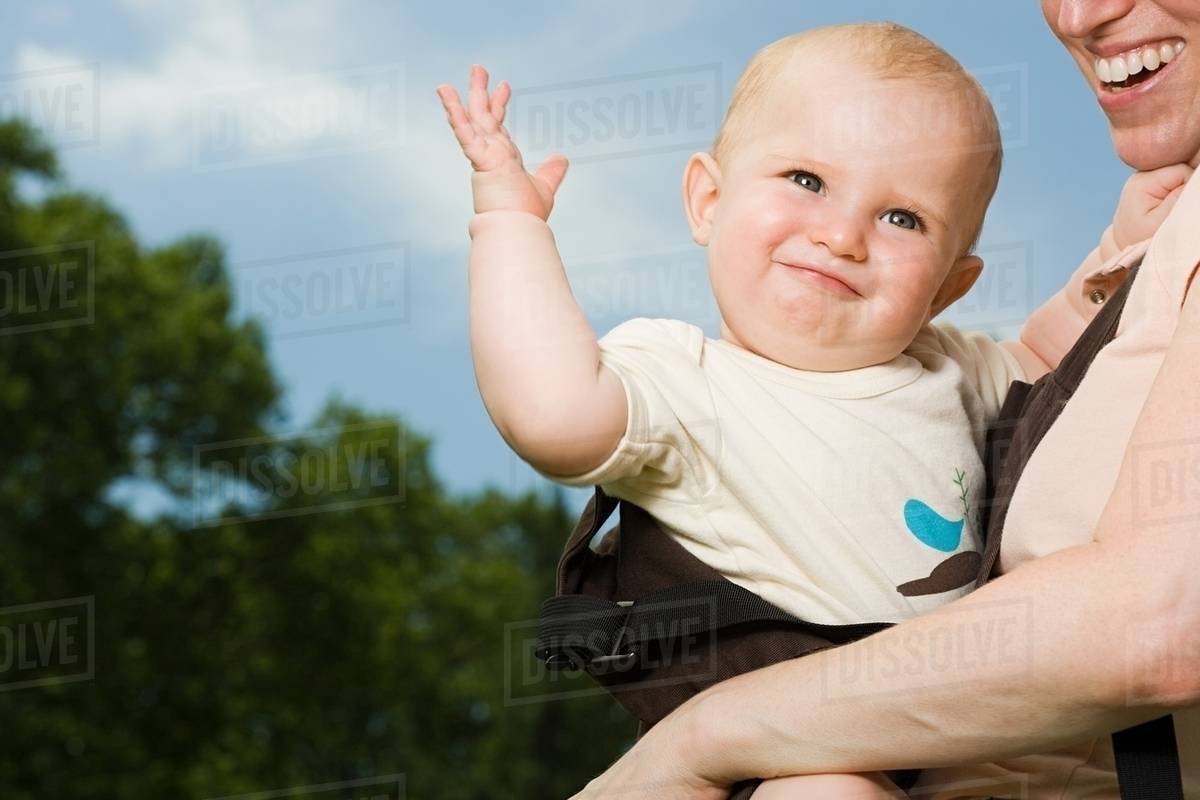 Mother carrying baby Stock Photo Dissolve