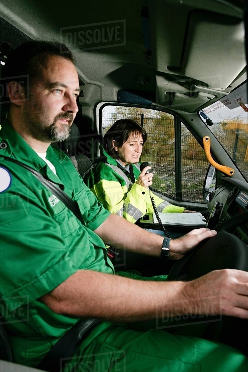 Driver and radio operator in ambulance Stock Photo Dissolve