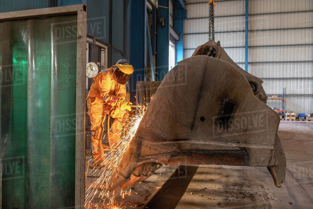 Man using acetylene burner in engineering factory Stock Photo Dissolve