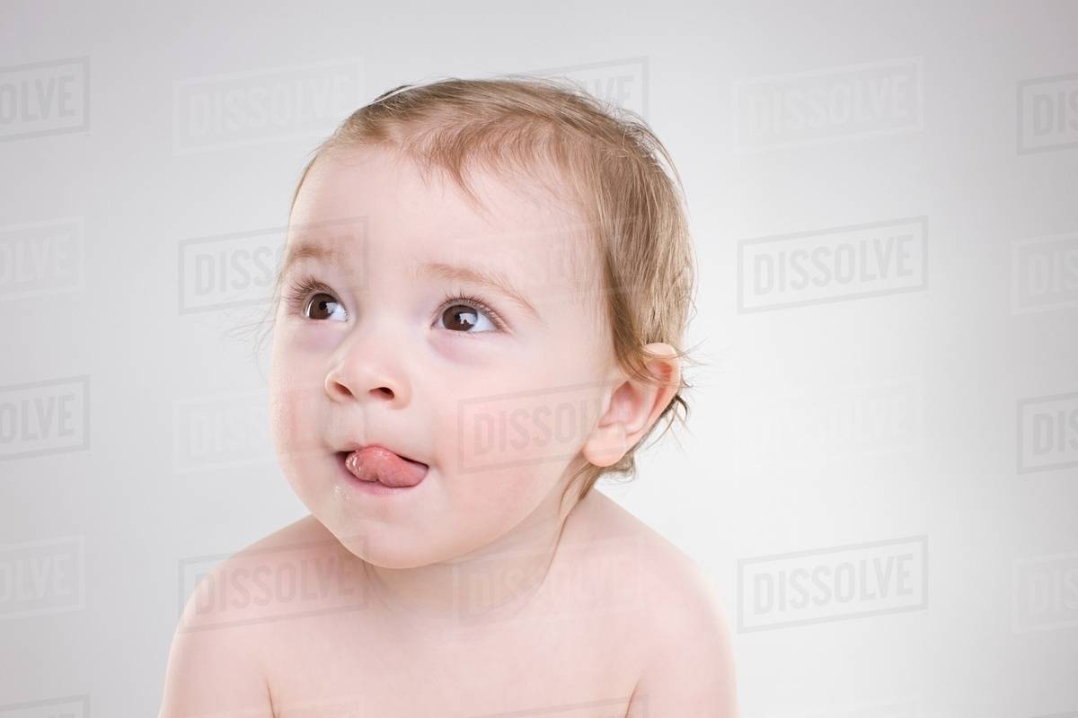 Baby sticking out tongue Stock Photo Dissolve
