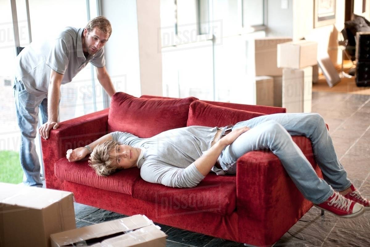 Two Removals Men One Lying On Sofa Stock Photo Dissolve Two Removals Men One Lying On Sofa