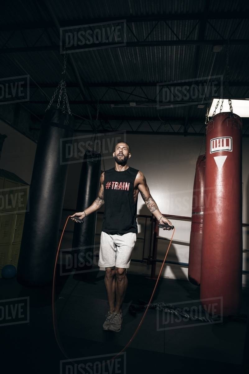 Male boxer training on skipping rope in gym Stock Photo Dissolve