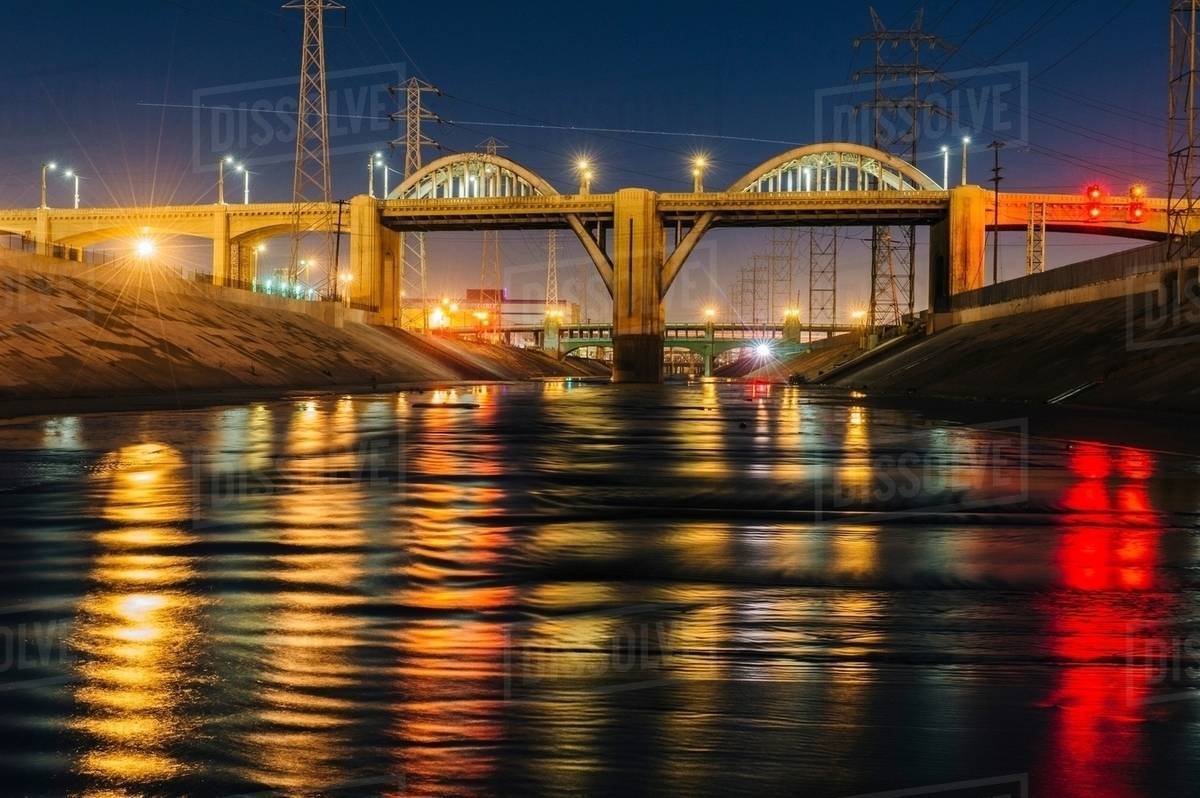 Diminishing perspective of Los Angeles river and 6th street bridge illuminated at night, Los Angeles, California, USA Royalty-free stock photo