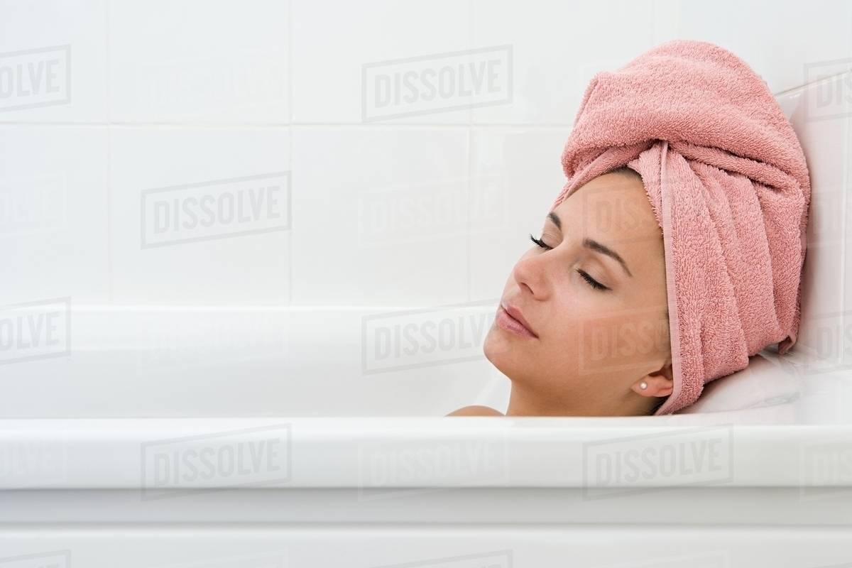 Woman sleeping in bath Stock Photo Dissolve