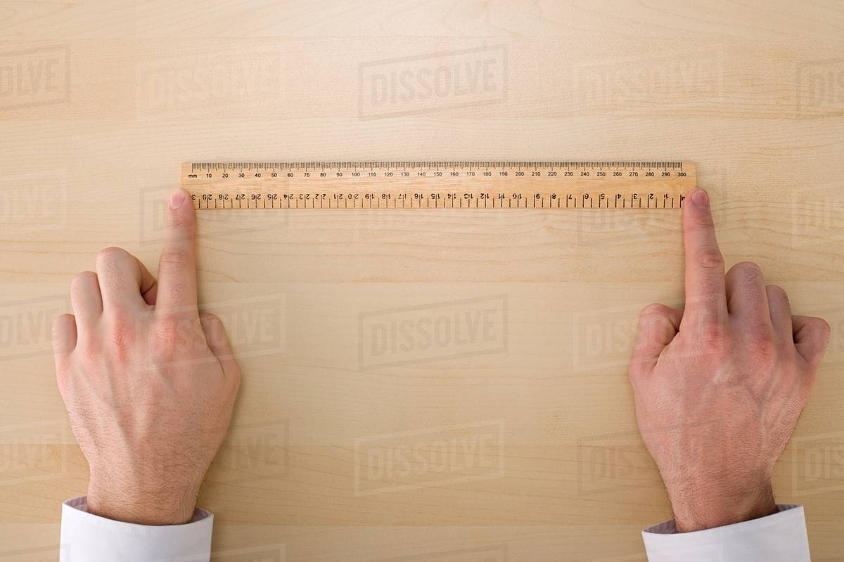 Person with a ruler Stock Photo Dissolve