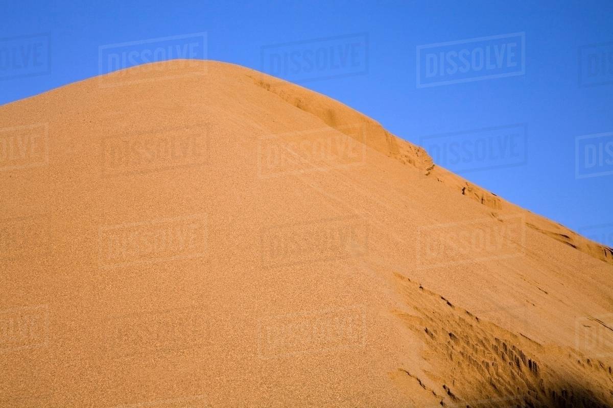 Mound of sand in commercial sandpit Stock Photo Dissolve