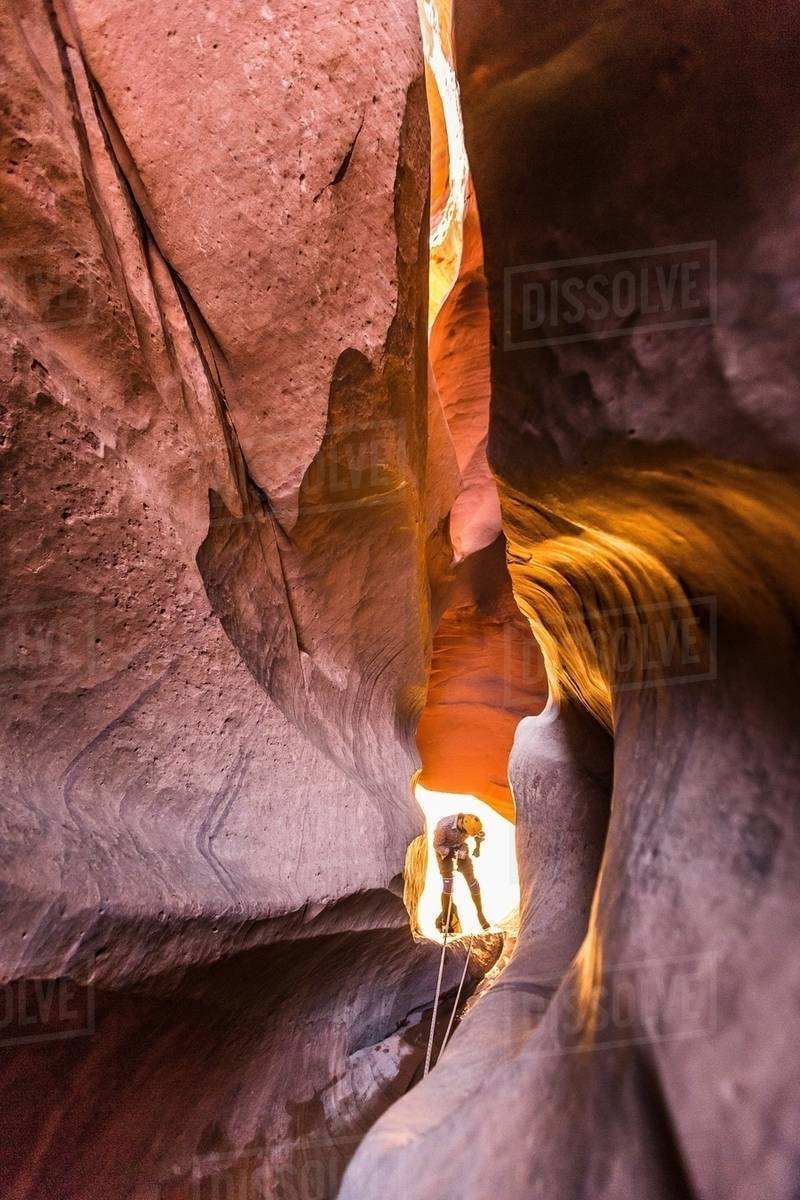 Climber canyoning in Neon Canyon - Stock Photo - Dissolve