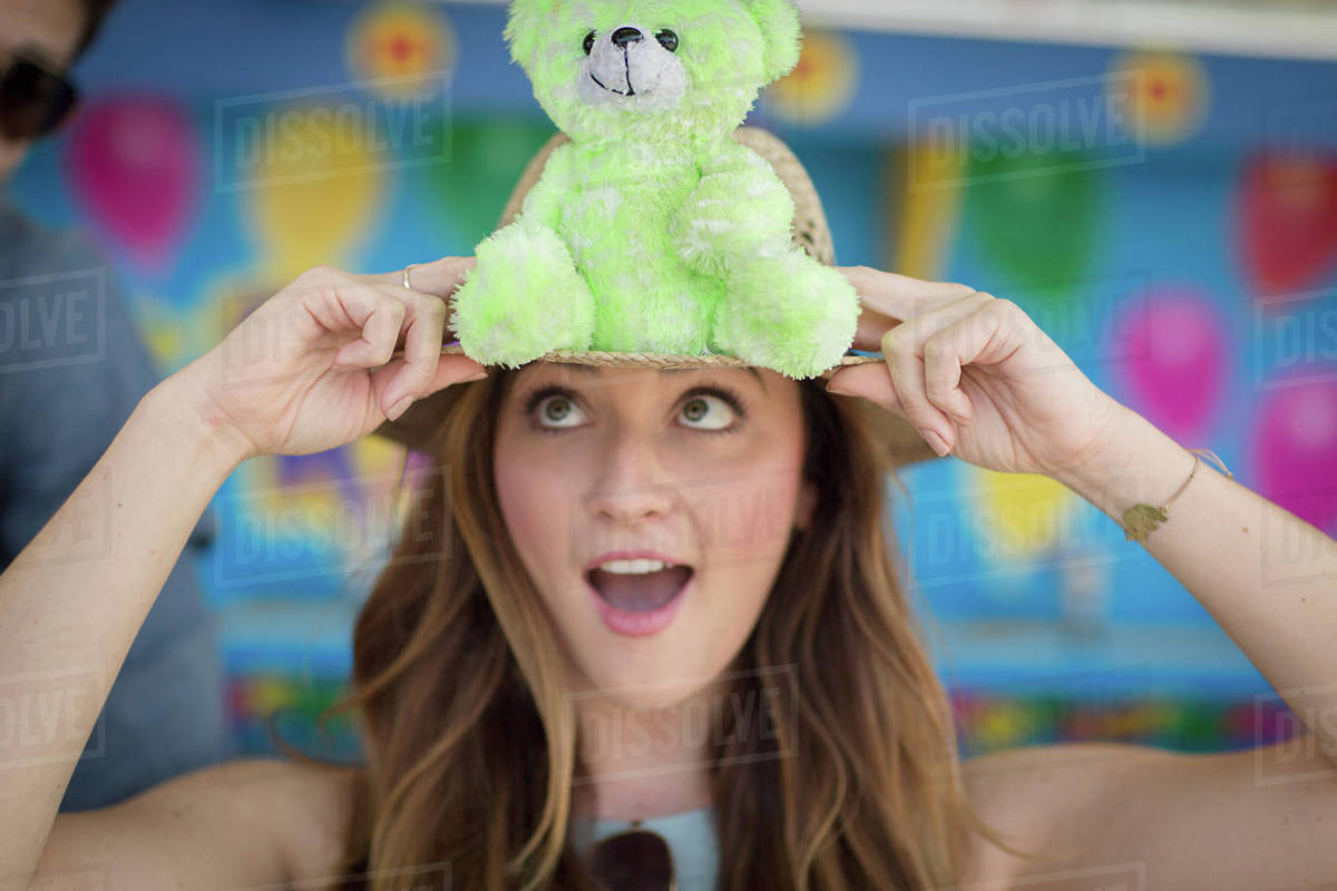 Woman holding teddy bear, pulling face, Coney island, Brooklyn, New