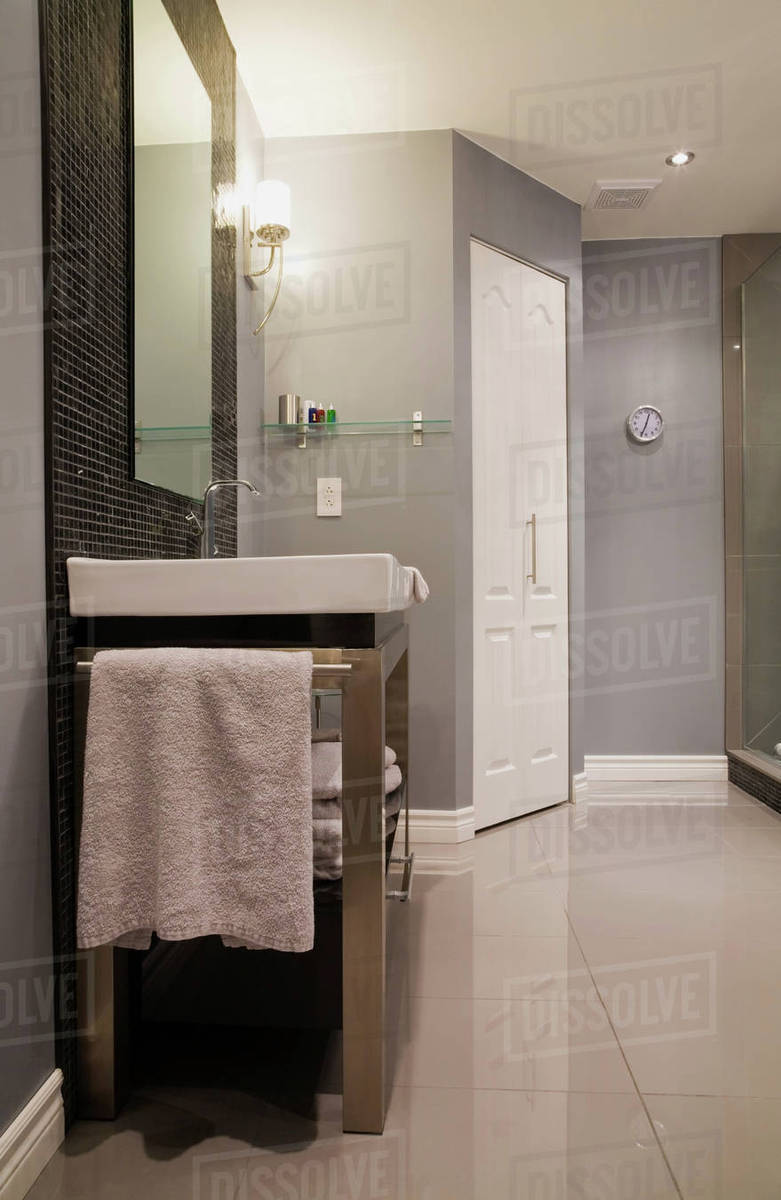 Bathroom with stainless steel vanity inside a luxurious home, Quebec, Canada Stock Photo