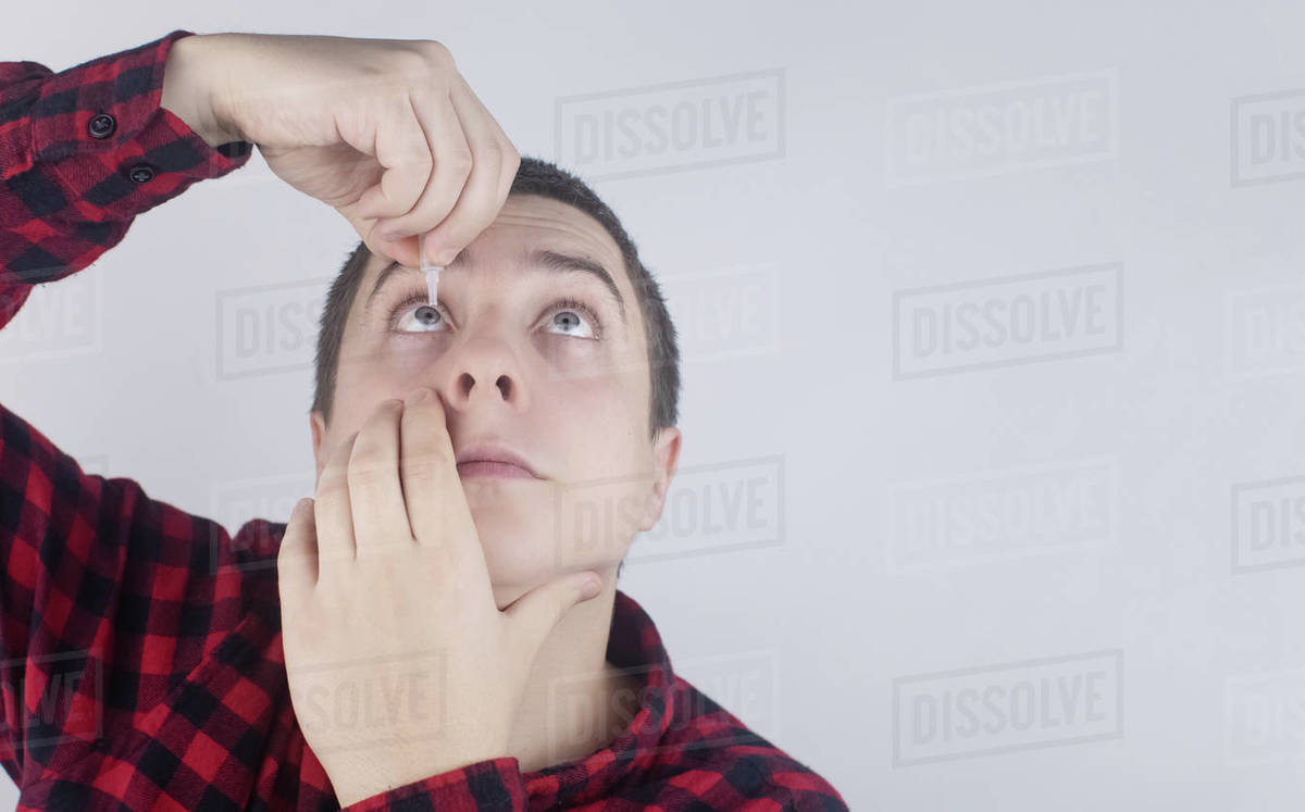 Closeup of eye drops. Artificial tear. Pain in the eyes. Sensation of grit in the eyes. Stock