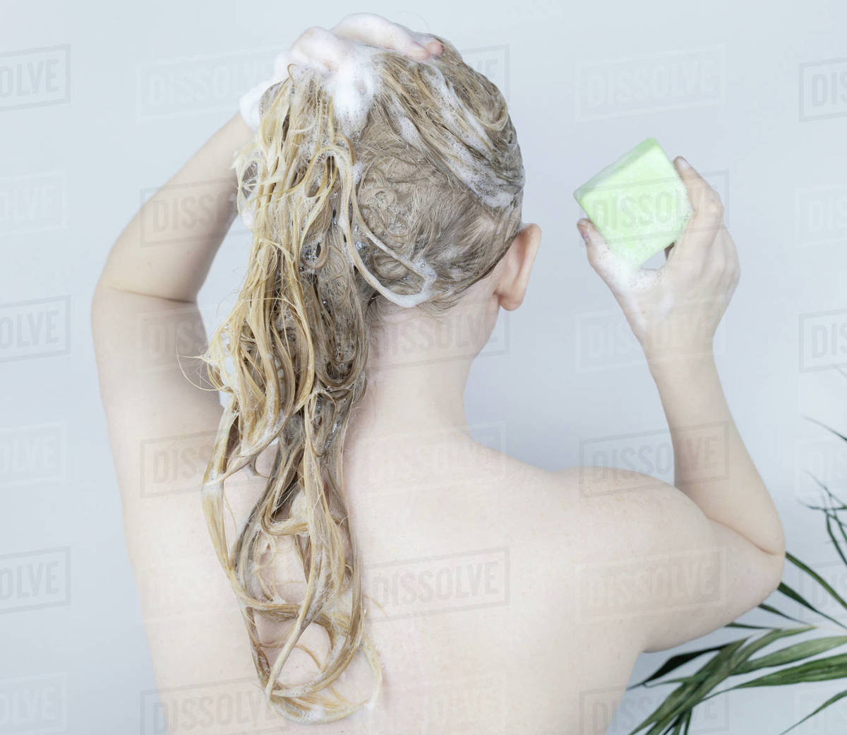 Happy woman with shiny hair using sulfate free shampoo