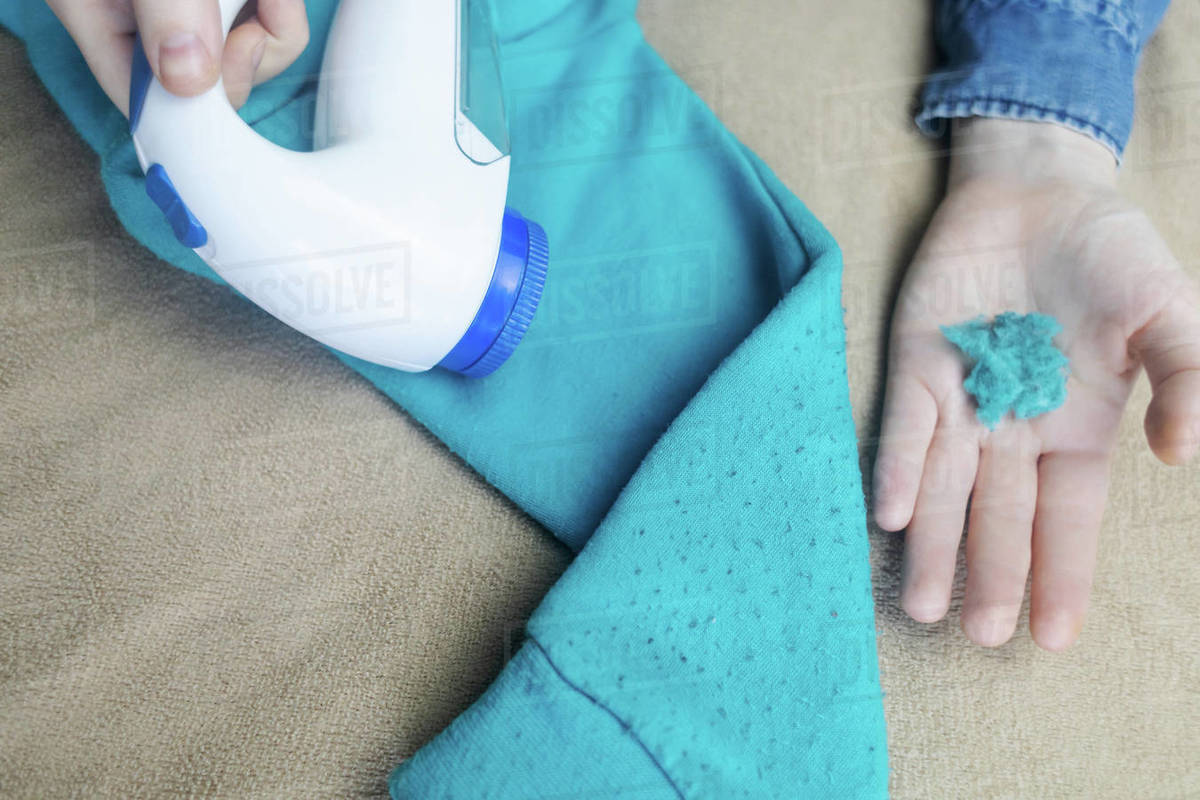 Machine for removing pellets. The girl uses a special device to remove