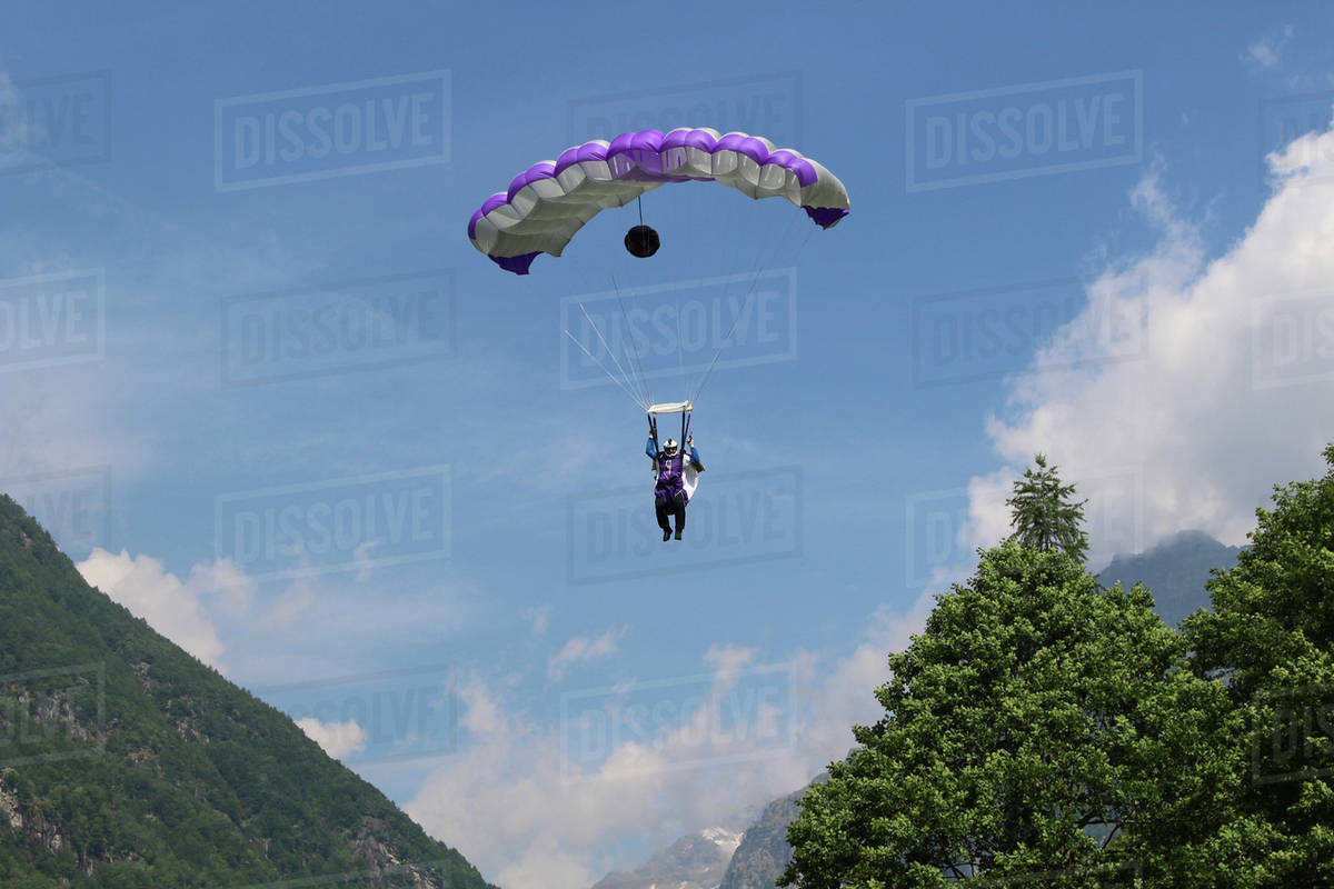 Wingsuit flyer gliding in the sky in Ticino canton, Switzerland Royalty-free stock photo