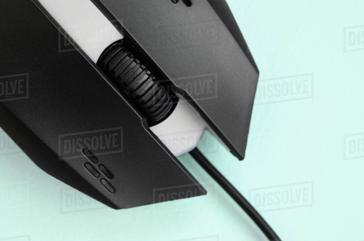 Closeup of a black gaming optical mouse on a blue background. Device ...