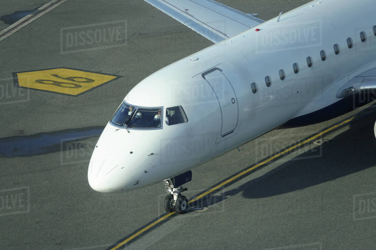 CLOSE UP Unrecognizable pilots sitting in the cockpit steer the