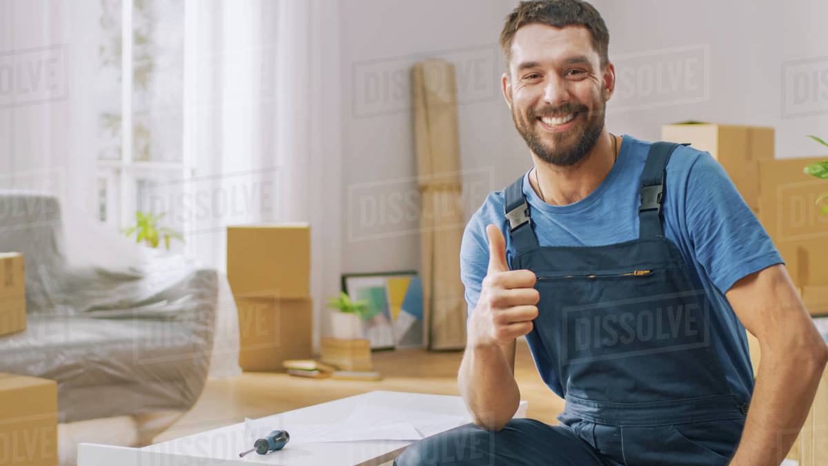 Successful furniture assembly worker finishes assembling shelf and