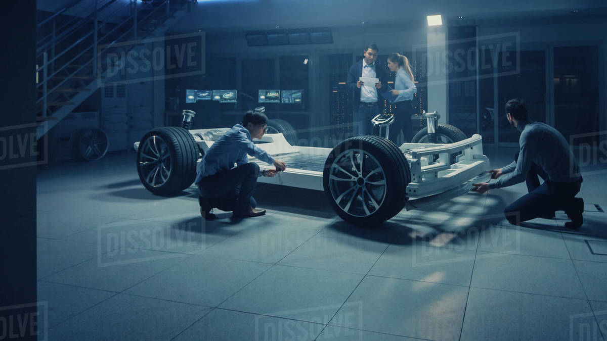 Team of Automotive Engineers Discussing and Designing Electric Car