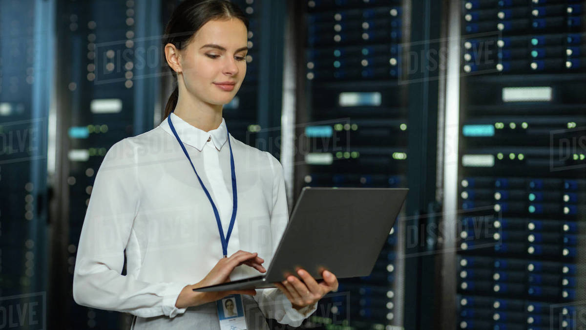 Beautiful Data Center Female IT Technician Standing Near Server Rack ...