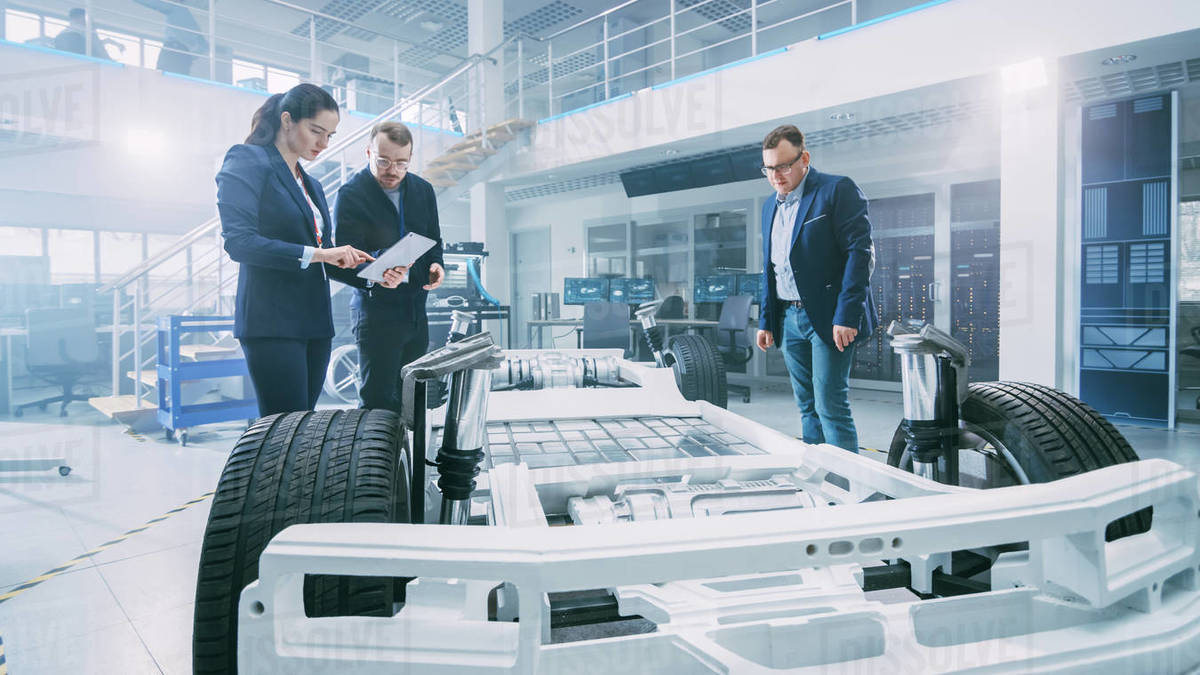 Automotive Design Engineers Talking while Working on Electric Car