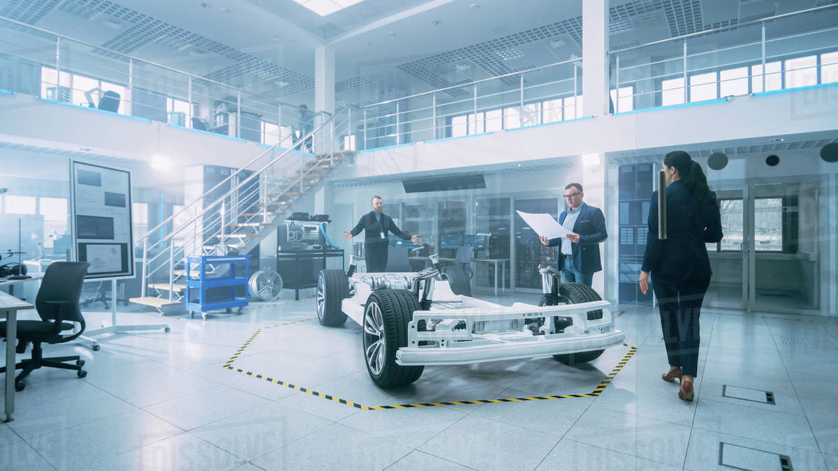 Automotive Design Engineers Talking while Working on Electric Car