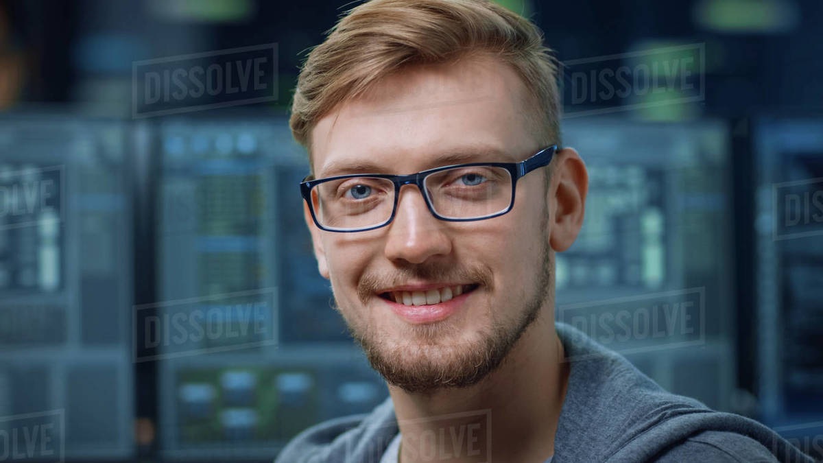 Portrait of a Smart and Handsome IT Specialist Wearing Glasses Smiles