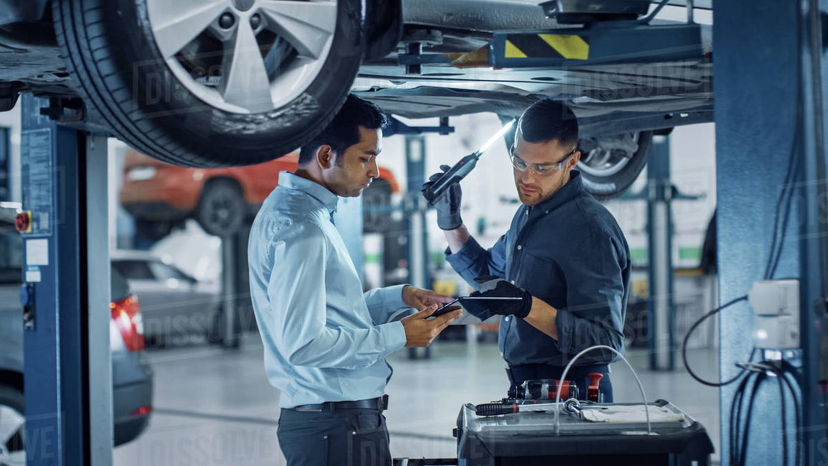 Manager Checks Data on a Tablet Computer and Explains the Breakdown to