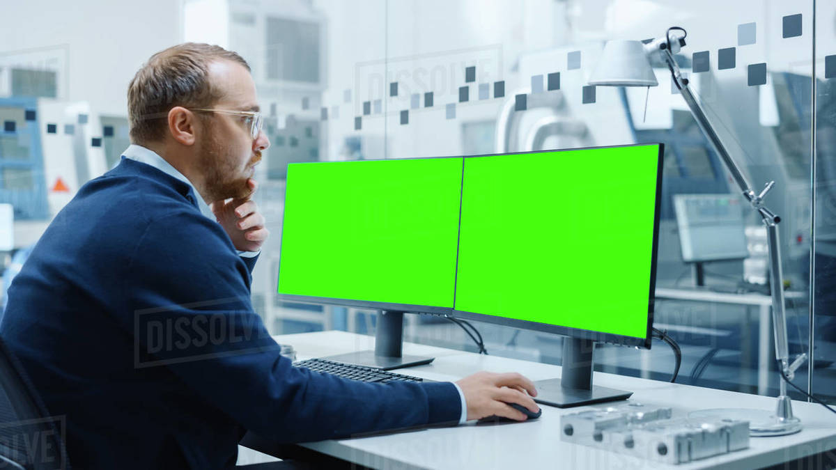 Industrial Engineer Working on a Personal Computer, Two Monitor Screens