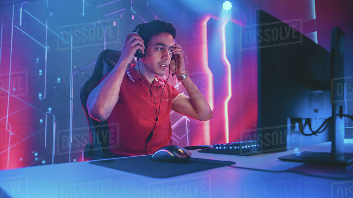 Professional eSports Gamer Sitting at Gaming Stations Stock Photo